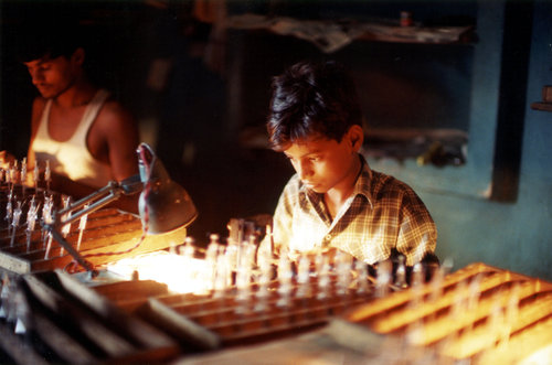 A young boy working at a light bulb factory in India. )Photo by Robin Romano/University Library Archives Special Collections)