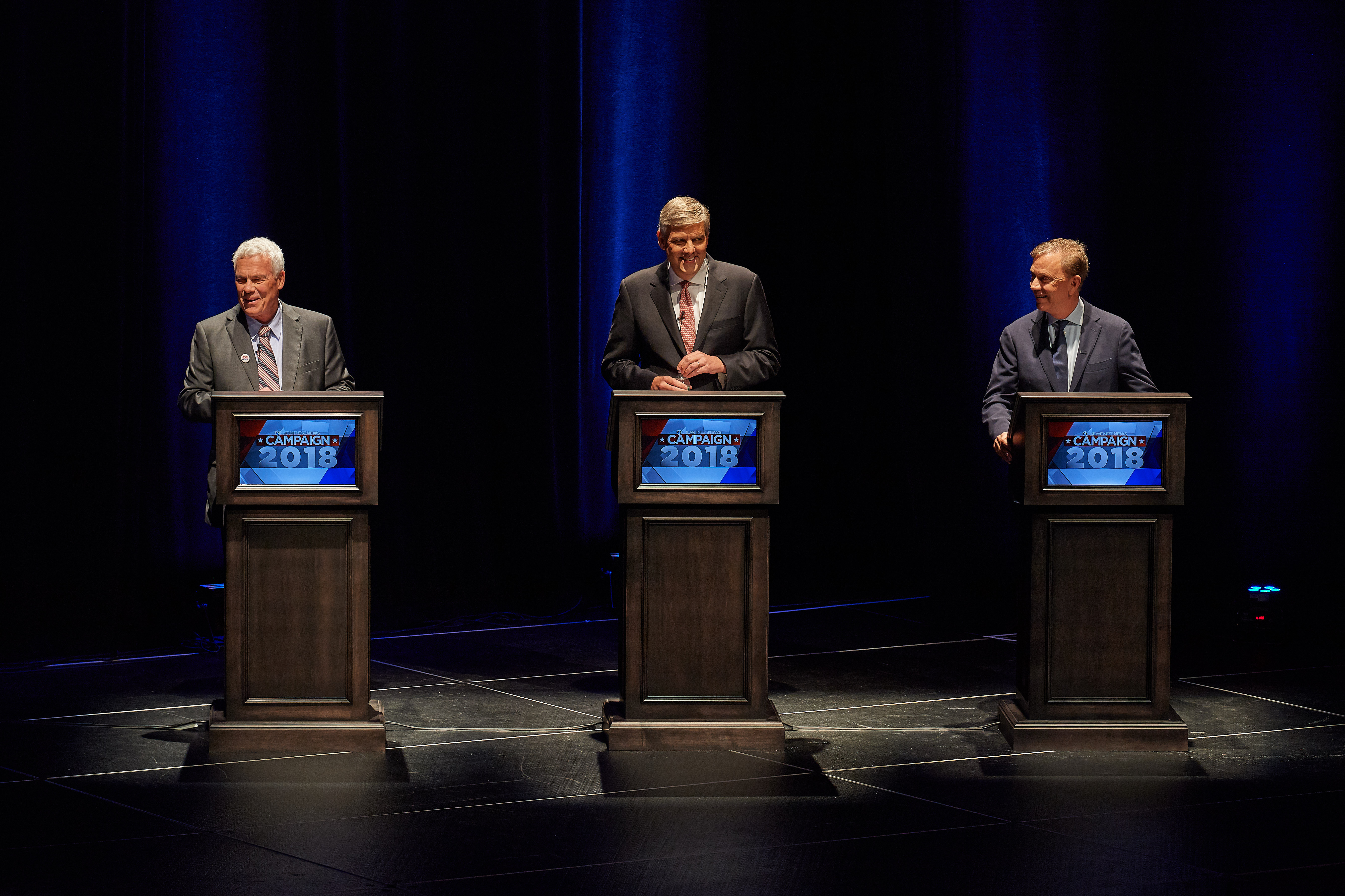 Candidates Oz Griebel, left, Bob Stefanowski, and Ned Lamont laugh as the gubernatorial debate starts at the Jorgensen Center for the Performing Arts on Sept. 26, 2018. (Peter Morenus/UConn Photo)
