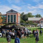 Students, faculty and staff check out Sikorsky Black Hawk, left, and S-76 helicopters on the Student Union Mall as part of Lockheed Martin Day on Sept. 27, 2018. (Peter Morenus/UConn Photo)