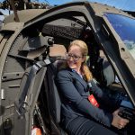 Cara Workman '95 (CLAS), '17 MBA sits at the controls of a Sikorsky Black Hawk helicopter on the Student Union Mall during Lockheed Martin Day on Sept. 27, 2018. (Peter Morenus/UConn Photo)