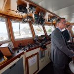 Provost Craig Kennedy and Robin Cote, associate dean of physical sciences in CLAS, check out the bridge of the R/V Connecticut after the recommissioning ceremony at the Avery Point campus on Sept. 13, 2018. (Peter Morenus/UConn Photo)