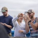 Anne Longo ’20 (CLAS), a political science and environmental studies major, and Samuel Urban ’20 (CLAS), a history, anthropology, and political science major, look at a jar filled with gelatinous plankton caught off the coast of Long Island Sound. (Bri Diaz/UConn Photo)