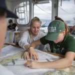 Anne Longo ’20 (CLAS) and Amanda O'Lear ’20 (CLAS), an environmental studies and geography major, work on a group chart navigation exercise. (Bri Diaz/UConn Photo)