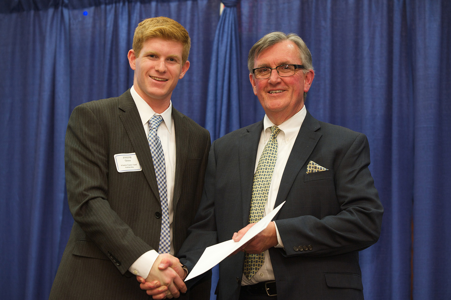 In this 2014 file photo, Professor Larry Gramling, then associate dean of Undergraduate Programs, poses with scholarship recipient Joseph Quinn during the Accounting Honors Banquet. (Kim Bova/UConn School of Business)