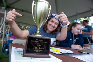 August Biondi '20 (CLAS) highlights the first place trophy the teams competed for during Learning Communities Field Day. (Defining Studios Photography for UConn)