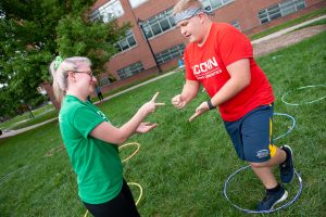A member of Business Connections House (left) plays Hula Hoop, Rock, Paper, Scissors with a member of Eurotech House. (Defining Studios Photography for UConn)