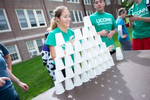 Business Connections House students strategize to build a pyramid of paper cups and return them to one pile in 60 seconds or less. (Defining Studios Photography for UConn)