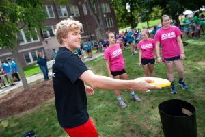 A member of Connecting with the Arts House prepares to throw a flying disc in the Kan Jam competition. (Defining Studios Photography for UConn)