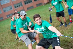 Members of Business Connections House, including house president Zach Solomon (front), engage in a tug'o'war. (Defining Studios Photography for UConn)