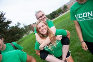 A member of Business Connections House gets a piggyback ride from a friend during Learning Communities Field Day. (Defining Studios Photography for UConn)