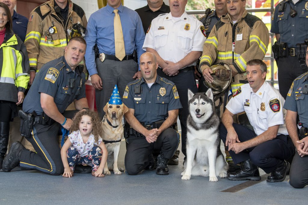 The UConn Fire and Police Departments along with a police dog sing Happy Birthday to Jonathan the husky dog. (Sean Flynn/UConn Photo)