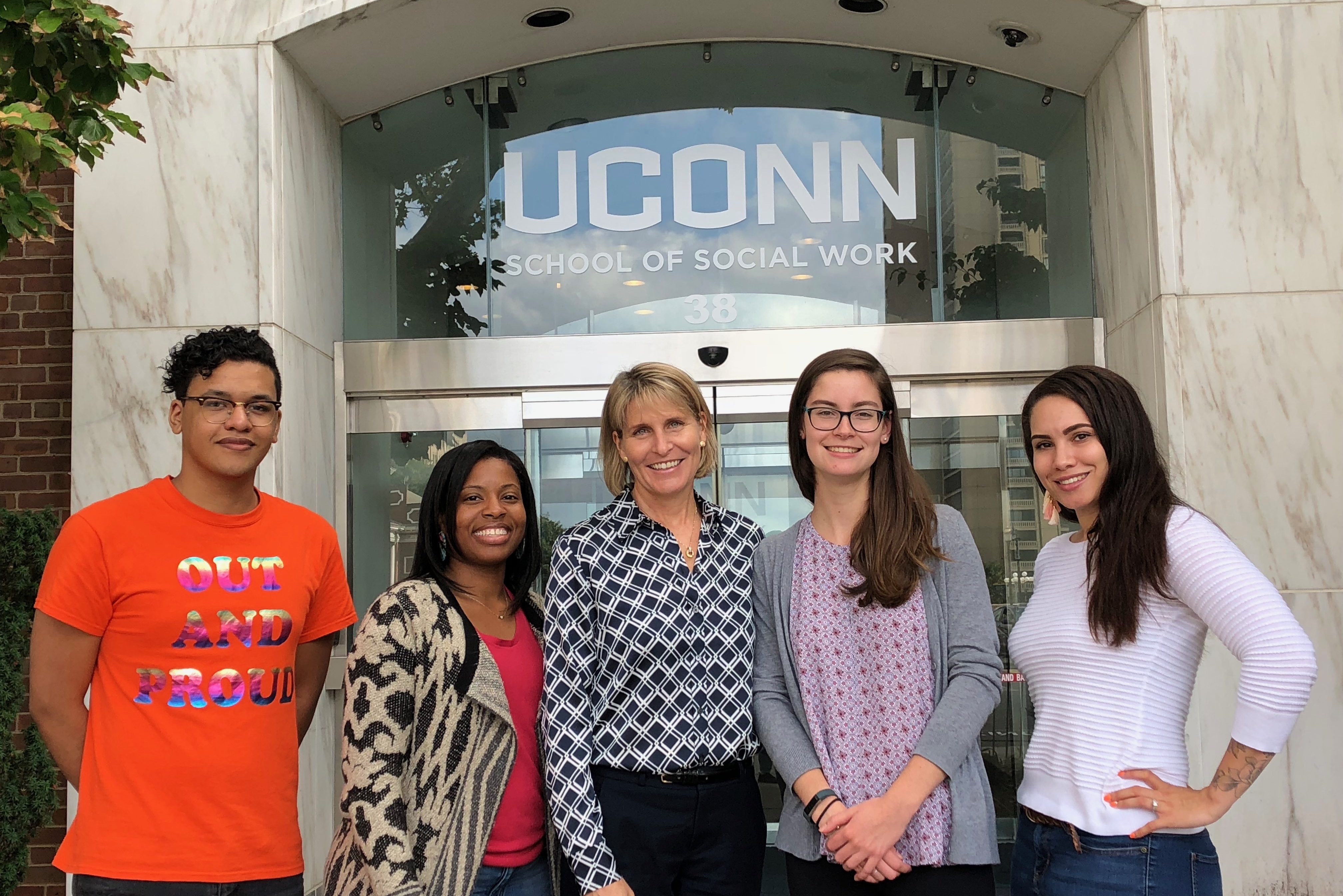 Tanya Rhodes Smith, director of UConn's Nancy A. Humphreys Institute for Political Social Work (center) with students.