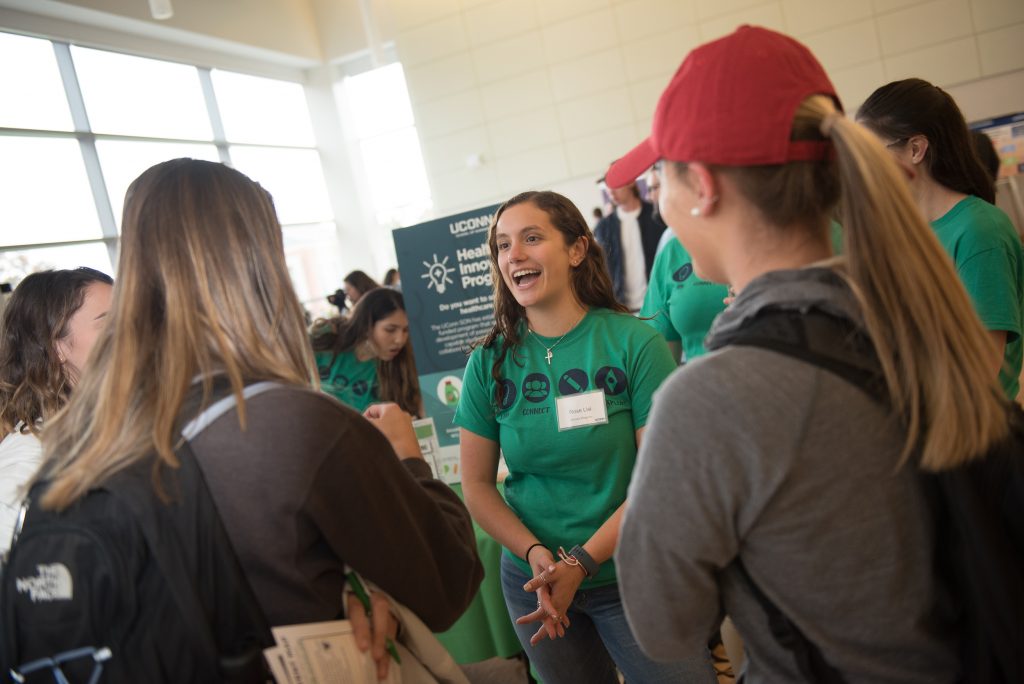 Rose Lisi, a student in the Honors Program, discusses the opportunities available on campus during the Innovation Expo on Oct. 29. (Nathan Oldham/UConn Photo)