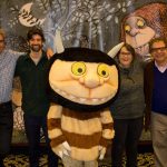 From left, Sendak Foundation Fellows Stephen Savage and Doug Salati are joined by curator Jonathan Weinberg, director Lynn Caponera, and a costumed character Wild Thing for a photo in front of a mural from Maurice Sendak’s world-famous book 'Where the Wild Things Are.' (Lucas Voghell '20 (CLAS)/UConn Photo)