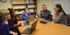 Researchers from UConn's Neag School of Education hold their first PBIS team meeting. From left, Susannah Everett, Tamika La Salle, Jen Freeman, Adam Feinberg, and Brandi Simonsen. (Shawn Kornegay/UConn Photo).