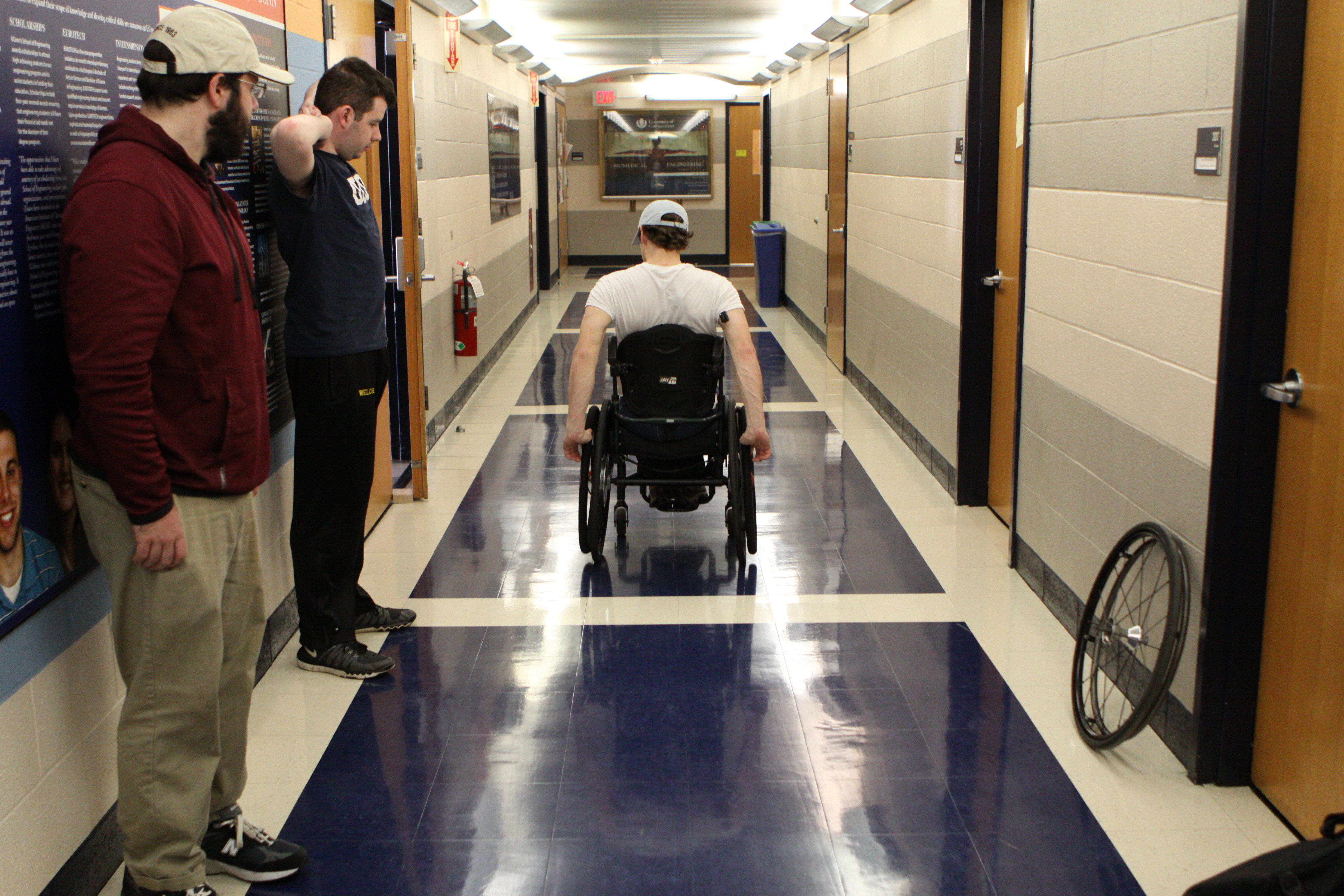 Mitchell DuBuc, center, tests the new wheels in the Arthur B. Bronwell Building at UConn. (Eli Freund/UConn Photo)