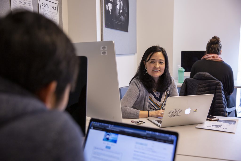 Marie Shanahan, associate professor of journalism, works with students in her JOUR 4016: Publication Practice course on Nov. 1, 2018. (Bri Diaz/UConn Photo