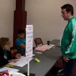 Joseph Kavgaci ‘19 (ENG), checks in with the election officials to receive his ballot and vote. (Lucas Voghell ’20 (CLAS)/UConn Photo)