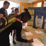 Sasha Richardson, a graduate student, signs the UConn PIRG petition at the Student Union to ban plastic bags in Dining Services locations on campus. Also shown are Alex Pawlka, left, and Tori Zane. (Photo courtesy of UConn PIRG)