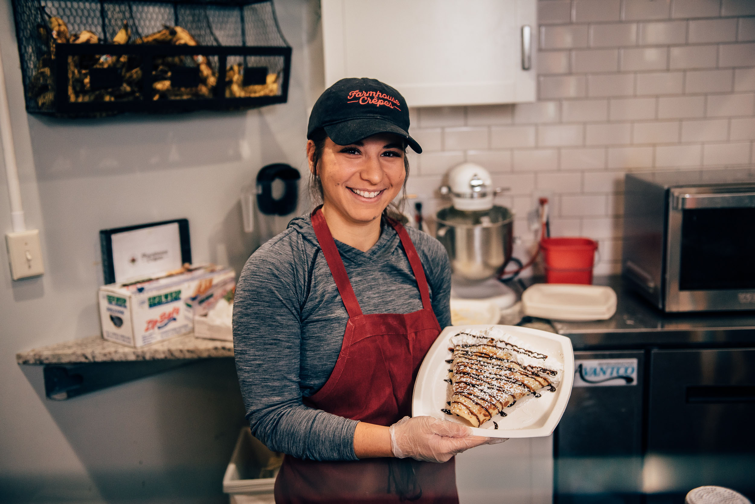 Finance major Ashley DeCarlo is a top student who holds down two jobs, a crepe expert, and – as head captain of the UConn cheerleading team – a self-described mom to 32. (Nate Oldham/UConn Photo)
