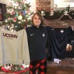 Maddox unwraps gifts of UConn gear from his team on Christmas Day. (Photo by Sherry Bruening)