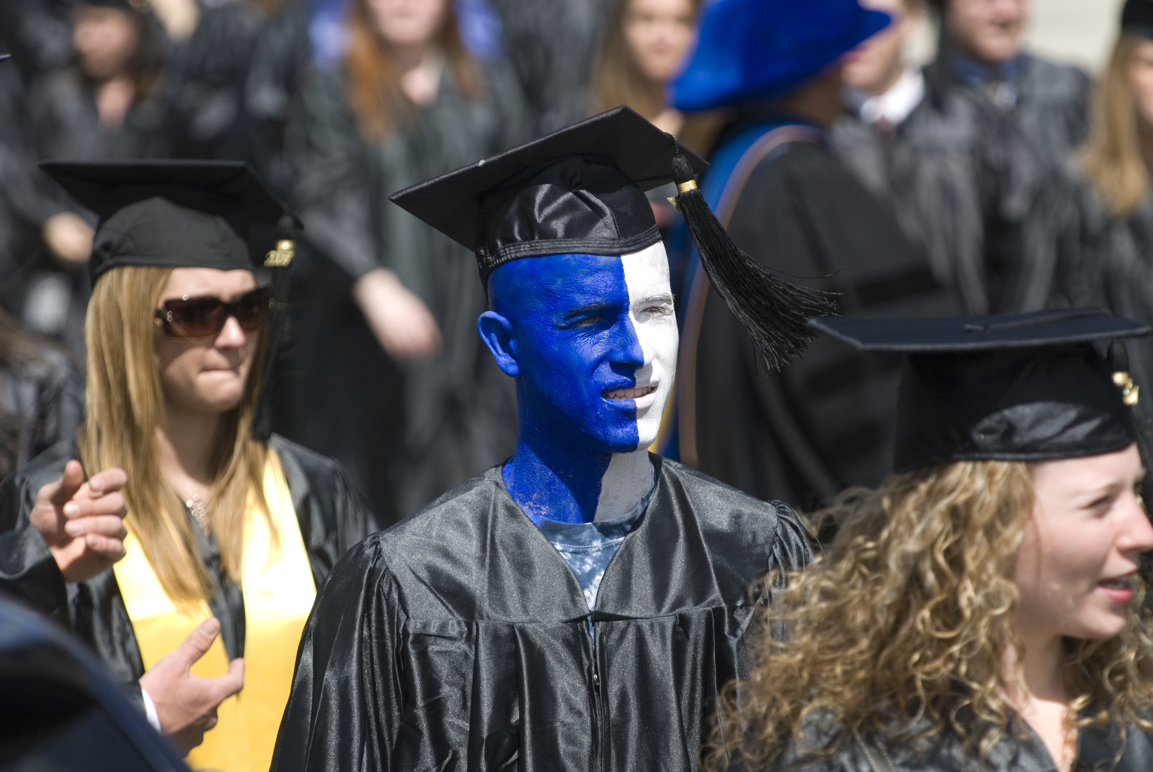 Dale Nosel, wearing blue and white paint, marches with his classmates along Fairfield Way during the the 2007 Commencement procession. (Peter Morenus/UConn File Photo)