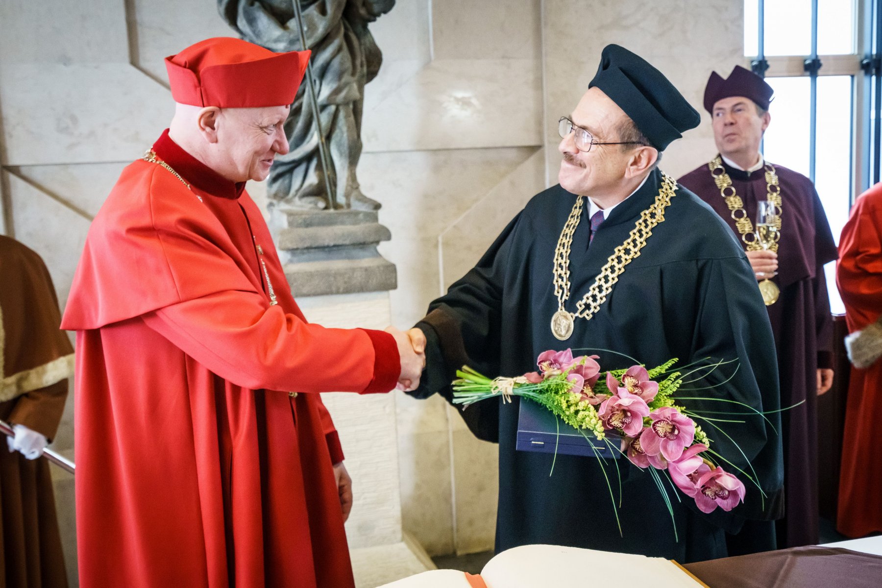 Olgac, right, receives his doctorate in a ceremony that took place on January 29. (Photo Courtesy of Czech Technical University )
