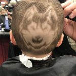 Rylan has his head shaved with the Husky dog logo. His mom says Coach Hurley has taken a particular interest in his hair-dos. (Photo by Tanya Ellingwood)