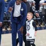 Mamadou Diarra speaks with Rylan on the court at the XL Center. (Stephen Slade '89 (SFA) for UConn)