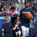 Rylan gives Tarin Smith a high five as the players return to the court after half-time at the XL Center in Hartford. (Stephen Slade '89 (SFA) for UConn)
