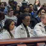 Fourth-year medical student Roshni Patel, left, testifies, as fourth-year dental student Chidera Amilo and clinical faculty member Christopher Steele listen, during testimony to the Appropriations Committee of the Connecticut General Assembly on March 7. (Ariel Dowski for UConn)