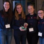 Kiera Burns ’21 (ENG), Christina Bibinski ’22 (CLAS), Olivia Tirelli ’22 (CLAS) and Megan Walsh ’21 (ENG) show off their GDD x19, a device used to quickly analyze blood samples and show blood sugar levels and insulin levels to aid in overdose identification. (Lucas Voghell ’20 (CLAS)/UConn Photo)