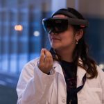 Norlinda Stewart ’22 (ENG) demonstrates her team’s idea of using Microsoft HoloLens technology to give nurses quick access to patient information. (Lucas Voghell ’20 (CLAS)/UConn Photo)