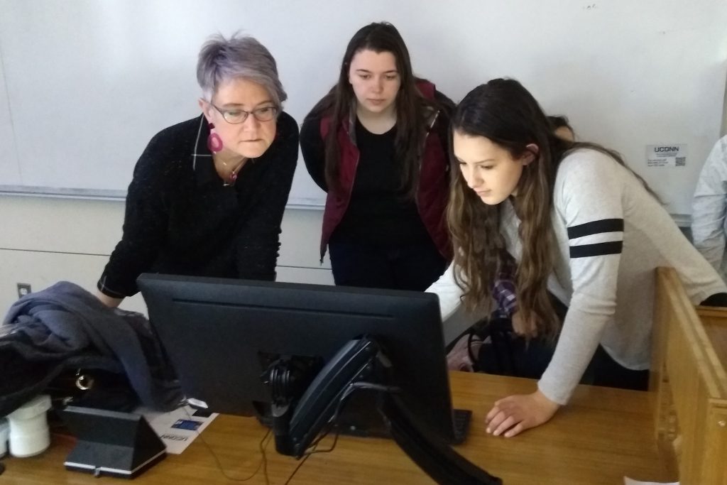 From left, Kelly Dennis, professor of art and art history; Megan Scholtz, ’19 (SFA), a photography major; and Deanna LaVoie ’20 (SFA), graphic design major, reviewing an updated biography in preparation for this year’s Art + Feminism Edit-a-thon during a History of Photography class in Oak Hall. (Kenneth Best/UConn Photo)