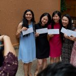 A group of medical students show off the envelopes containing their residency assignments before opening them at the  residency match day ceremony held in the Academic Atrium at UConn Health in Farmington on March 15, 2019. (Peter Morenus/UConn Photo)