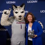 Cinnamon Adams of the Graduate School poses with Jonathan the Husky after receiving the university citizen award at the UConn Spirit Awards ceremony held at the Alumni Center on March 28. (Peter Morenus/UConn Photo)