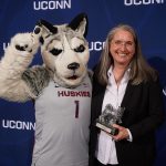Ellyssa Eror of Student Health Services poses with Jonathan the Husky after receiving the unsung hero award at the Spirit Awards ceremony. (Peter Morenus/UConn Photo)