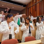 Second year dental students put on their white coats. (Peter Morenus/UConn Photo)