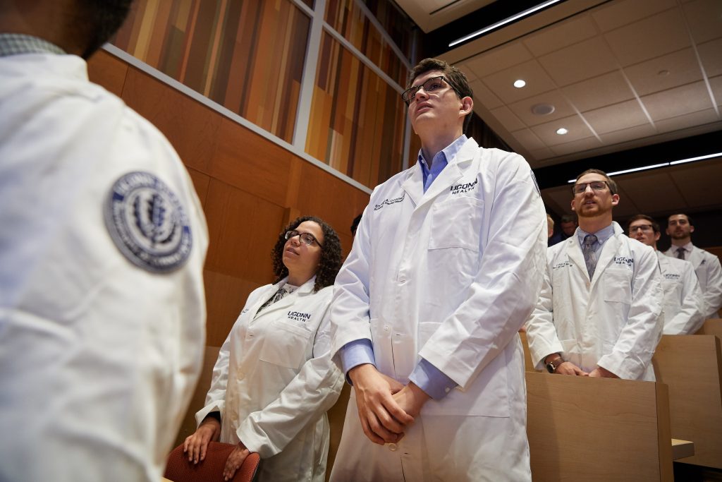 Second year dental students recite an American Dental Association pledge during a white coat ceremony on Friday marking their transition from theoretical to clinic-based learning. (Peter Morenus/UConn Photo)