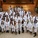 Second year dental students pose for a photo at the UConn Health academic atrium in Farmington following their white coat ceremony on March 22. (Peter Morenus/UConn Photo)