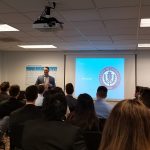 William Facteau '92 (CLAS) addresses the group of UConn students at Earlens Corp., where he is chairman, president and CEO. (Submitted Photo)
