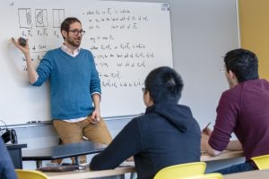 Math professor Damir Dzhafarov teaches a graduate class in logic in the Monteith Building. (Sean Flynn/UConn Photo)