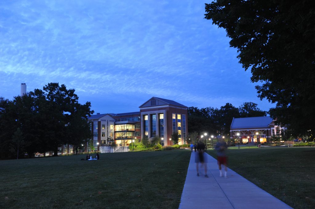 Students walking along the sidewalks of the Student Union Mall at night on Sept. 21, 2015. (Sean Flynn/UConn Photo)