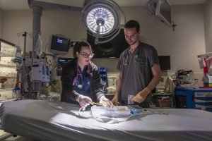 Amanda Moreau ’13 RN and Chad Eichman ’16 RN in the Emergency Department at UConn Health on March 6, 2019. (Sean Flynn/UConn Photo)
