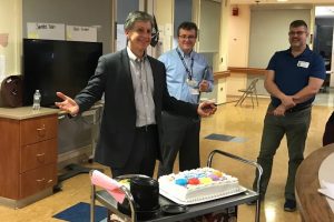 Chief Information Officer Bruce Metz presents a congratulatory cake to celebrate the arrival of UConn Health's new electronic health record April 28, 2018.