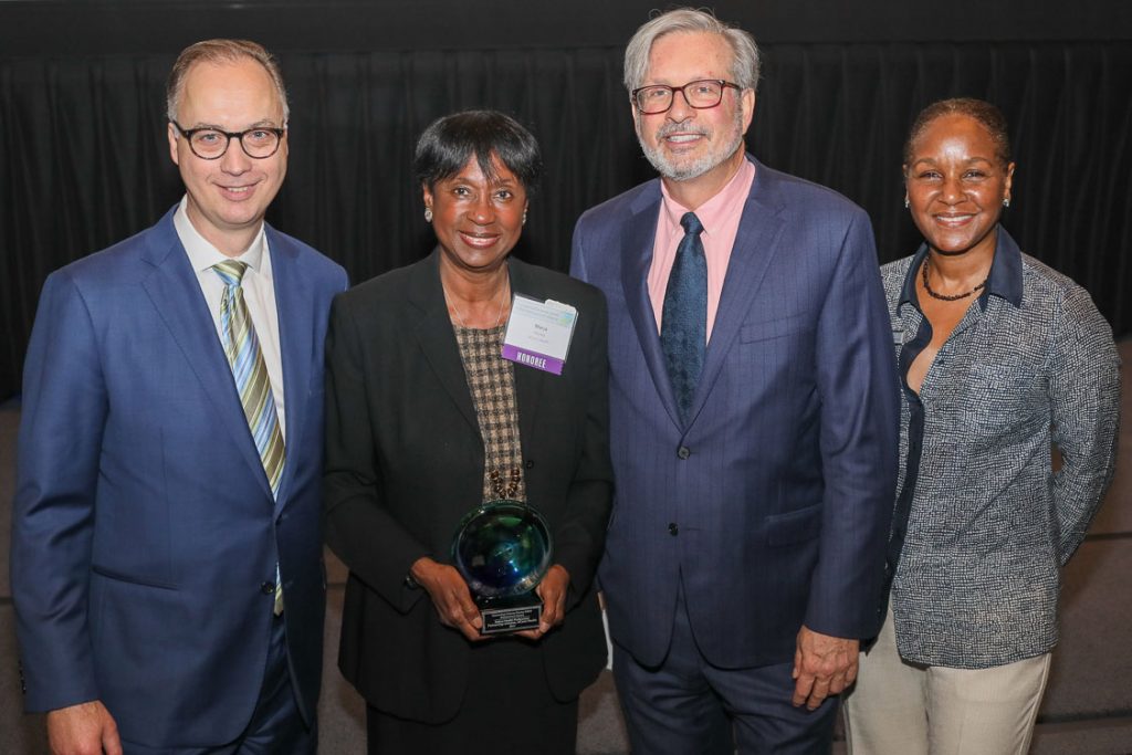 Dr. Marja Hurley accepts a 2019 STEM Achievement Award from Connecticut Science Center' Matt Fleury and Amy Sailor, and State Rep. William Petit.