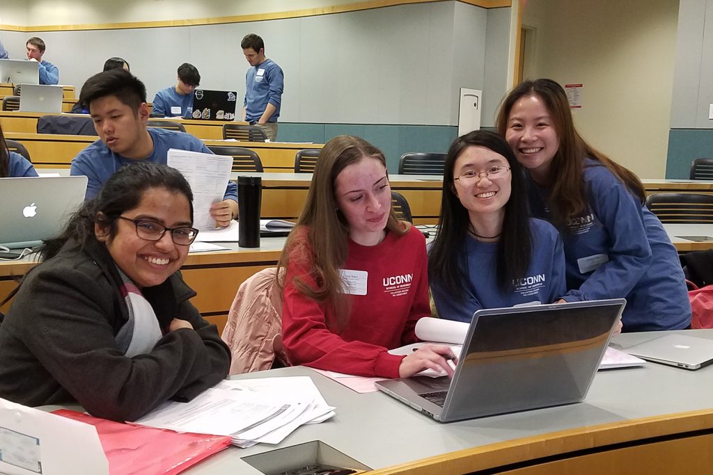 Volunteers prepared taxes for over 700 people this year in the VITA Program. From left, graduate student Debadarshini Mishra, second-year reviewer Nicole Holyst and first-year preparers Jenny Wei and Qingya Yang. (Leanne Adams / UConn School of Business)