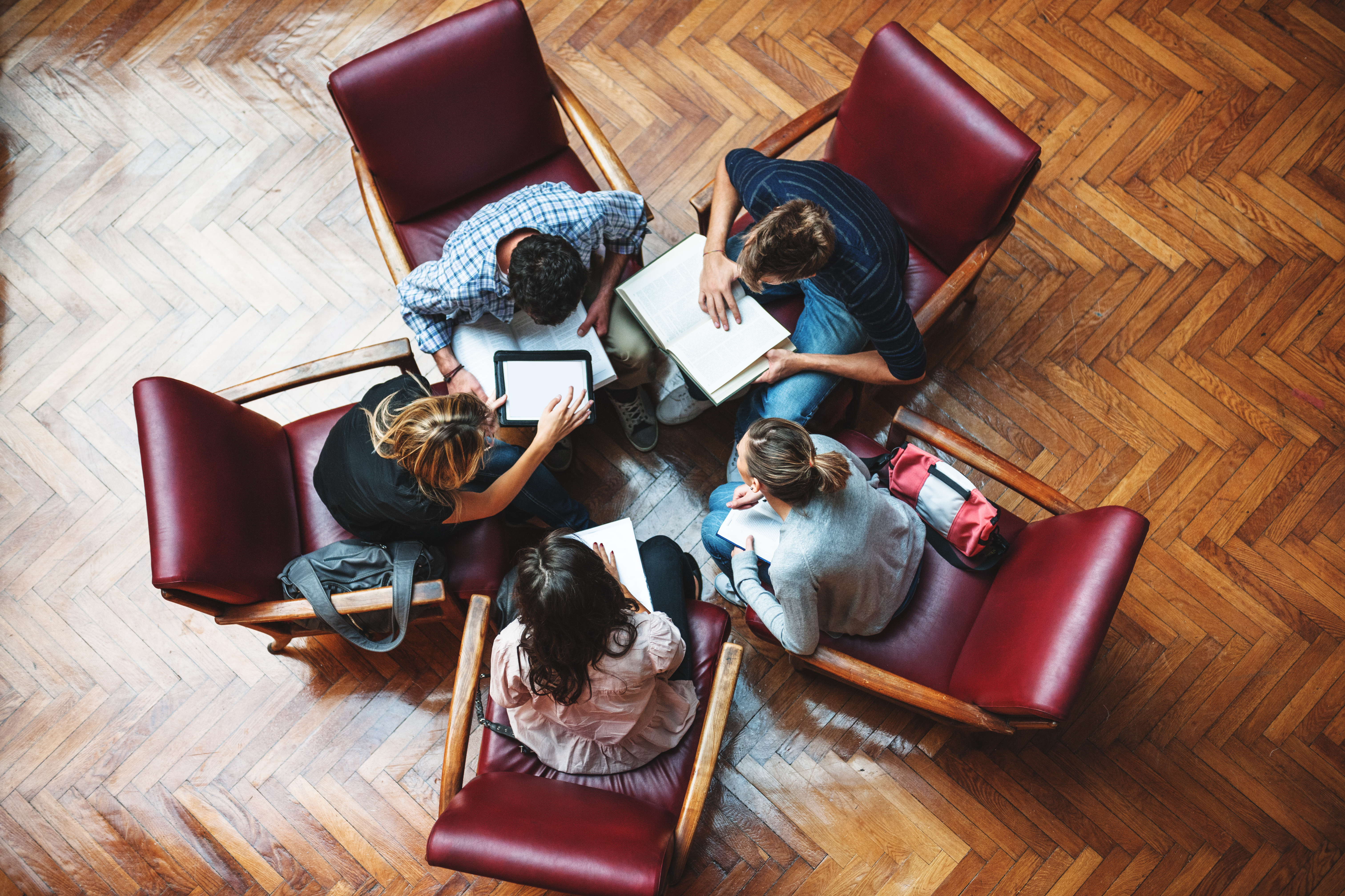 Meeting among scholars in a library. (Getty Images)