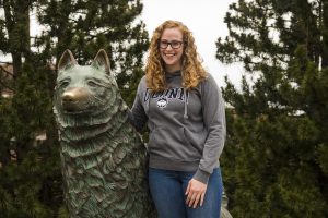 Kathrine Grant in front of the UConn Husky statue.