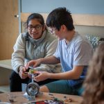 Kashvi Bokria, left, and Sophia Wong from Timothy Edwards Middle School in South Windsor, Connecticut, build a cantilever beam out of common materials to learn more about engineering. (Christopher LaRosa/UConn Photo)